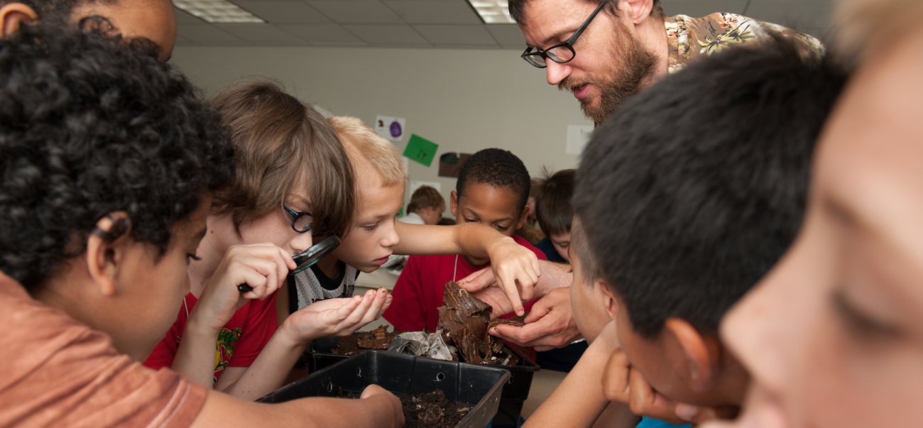 Kids working in an OU class setting with a teacher.